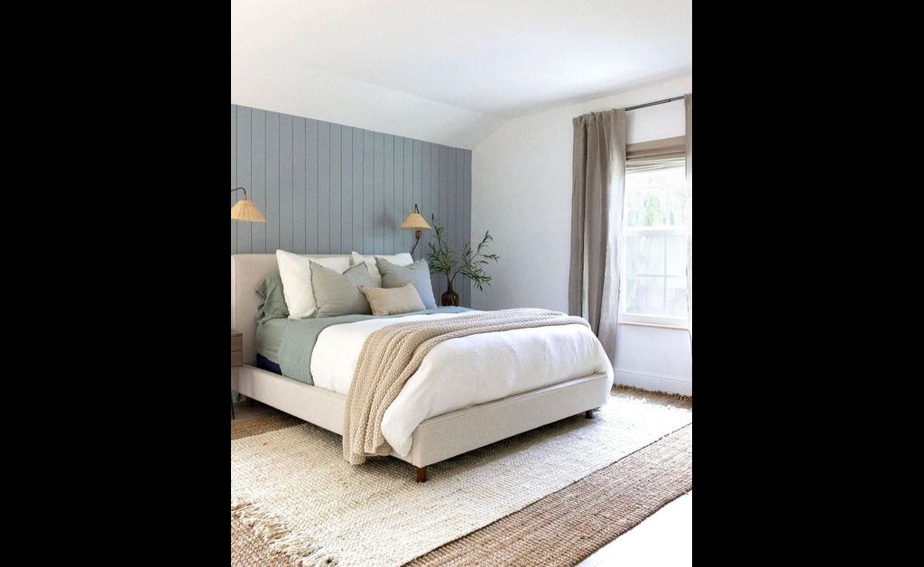 Farmhouse style lamps placed on side tables of bed.