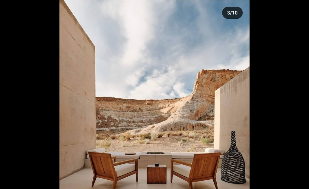 two rattan chairs and a woven basket in open desert.