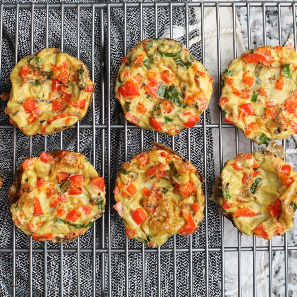 six omelets muffins placed on the grill.