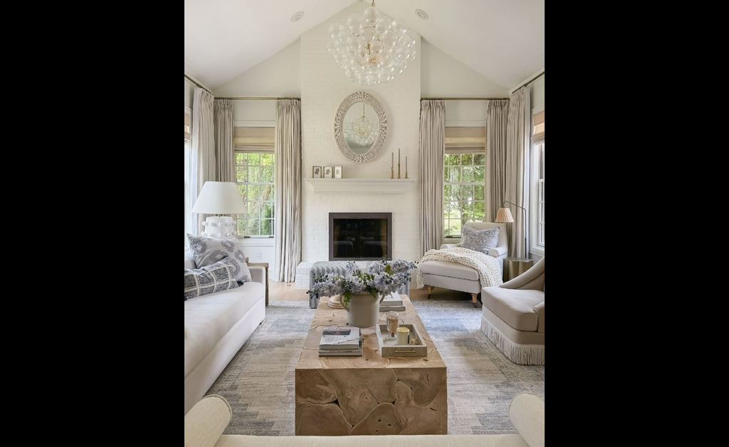 A beautiful white farmhouse chic living room .