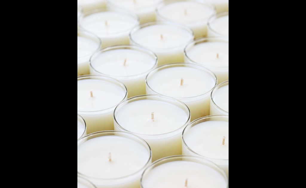 all white candles in glass jar.