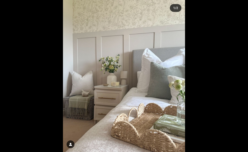 rustic woven basket placed on bed. the other one is in grey color placed next to side table.