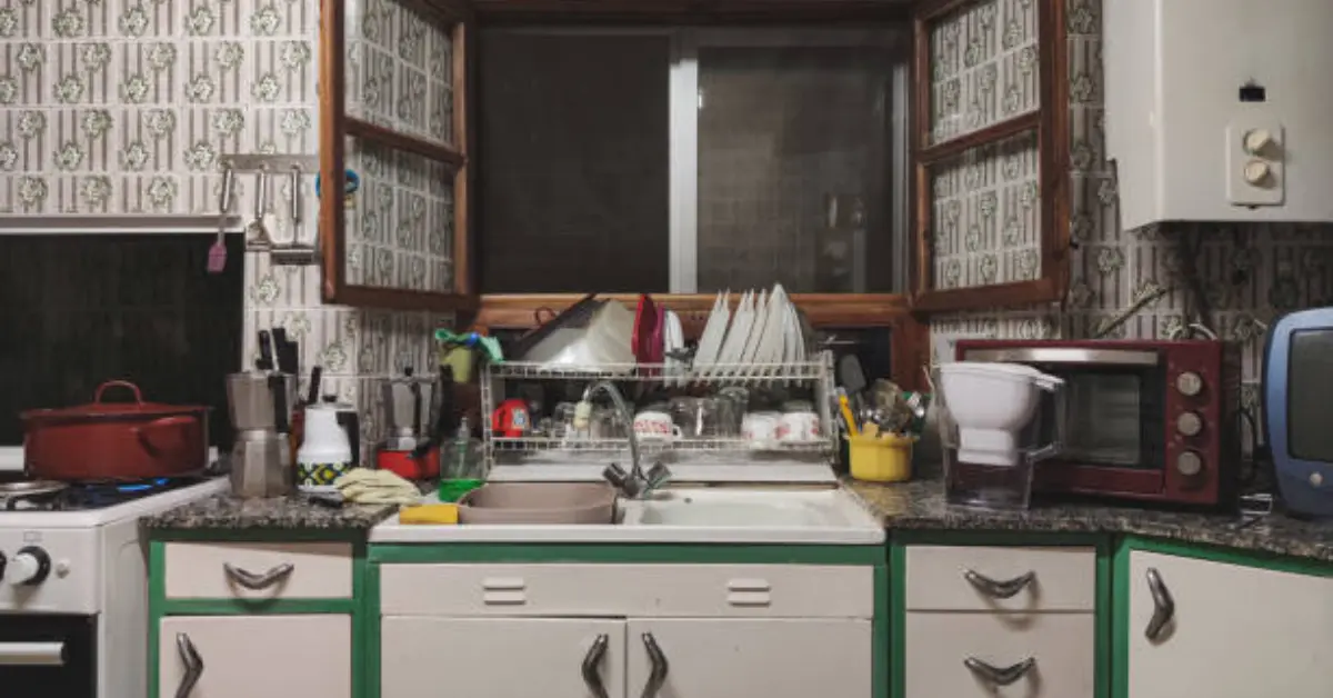 sink with utensils rack over it.