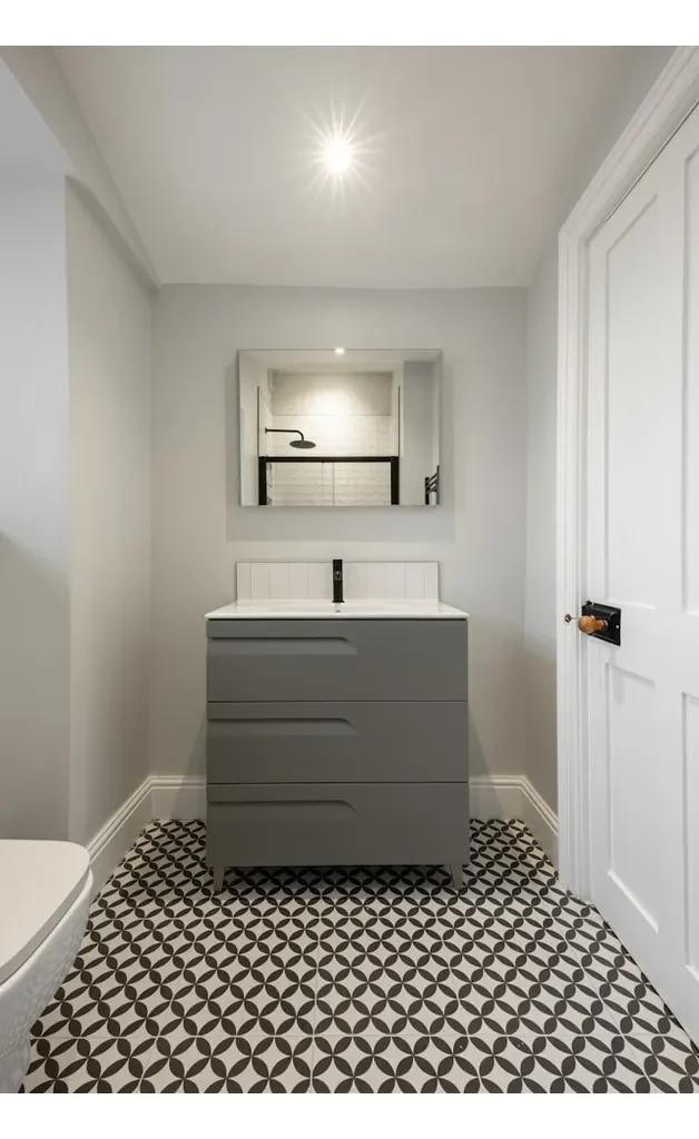 dark grey and white geomatric patterned tiles on japandi bathroom floor.