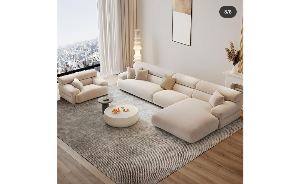 A clean off white low seating with tatmi mats on floor facng the large glass windoe in japanese-style living room.