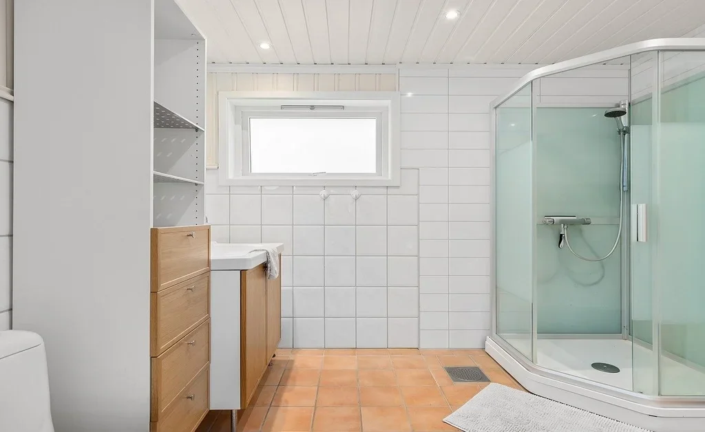 A large japandi bathroom with various storage options.