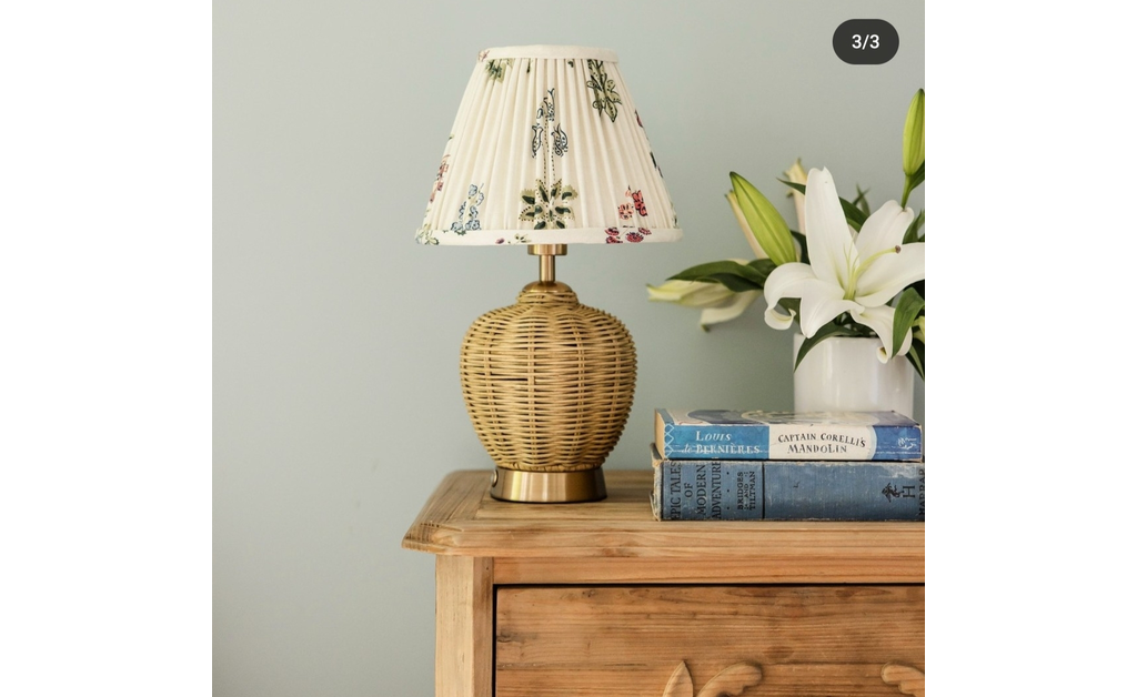 washi paper lamp shade on a bamboo lamp placed on a wooden drawer.