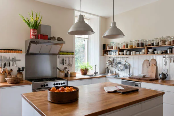 glass jars having spices and other items are placed neatly in open shelf over the counter. so deor pieces are also placed over the hood.